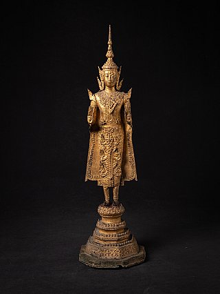 Thai bronze Buddha statue standing in Abhaya mudra, full front view on tiered base