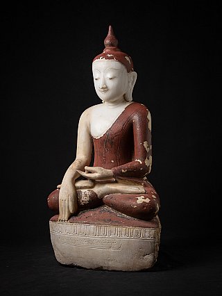 Shan-style Burmese marble Buddha statue, three-quarter view showing worn red painted robe