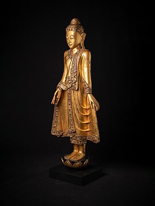 Antique wooden standing Buddha statue