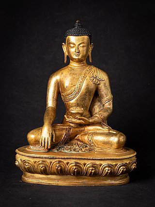 Nepali bronze Buddha statue seated on lotus base, full front view with bhumisparsha mudra