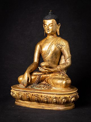 Buddha statue from Nepal in bronze, three-quarter view showing lotus base