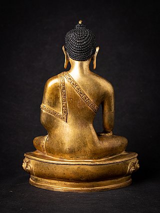Nepali bronze Buddha statue rear view, seated with robe strap across the back