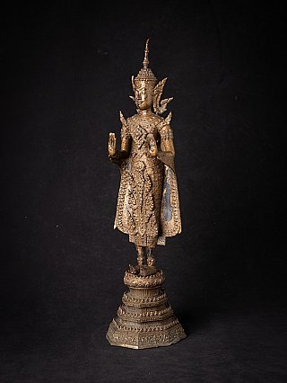 Bronze Buddha statue from Thailand, three-quarter view showing raised hand in Abhaya mudra