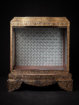 Antique wooden Burmese temple shrine with gilt frame and silvered patterned back panel, front view