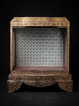 Antique wooden Burmese temple shrine with gilt frame and silvered patterned back panel, front view