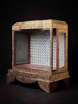 Antique wooden Burmese temple shrine, angled front view with the right side door ajar