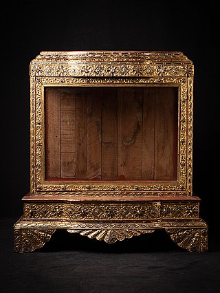 Antique Burmese wooden temple shrine with gilded carving, full front view of open niche