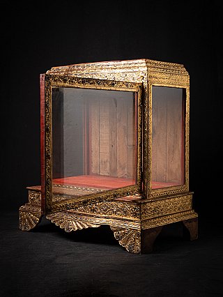 Burmese wooden temple shrine with gilded decoration, three-quarter view with open glass door