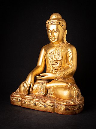 Burmese Mandalay Buddha statue in wood, three-quarter view showing robe and base