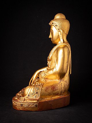 Burmese wooden Buddha statue, left side profile view with ushnisha and seated posture