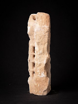Side view of the marble temple statue fragment, showing rough edge and pierced openings