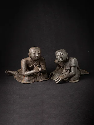 Pair of Burmese bronze monk statues seated, angled front view with namaskara mudra