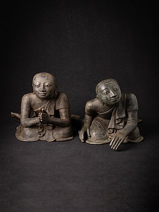Pair of Burmese bronze monk statues seated side by side, front view