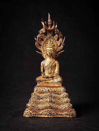 Thai bronze Buddha statue on Naga, seated in dhyana mudra, full-front view