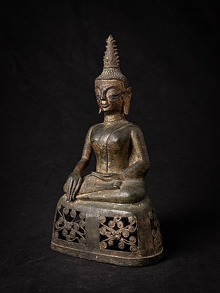 Buddha statue from Laos in bronze, seated, three-quarter view showing tall flame finial and pierced base