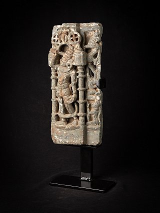 Indian temple relief panel in three-quarter view with standing figure and architectural frame