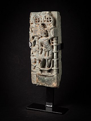 Indian temple relief panel with standing figure, three-quarter view showing depth