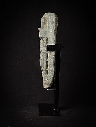 Side profile of the Indian relief panel on stand, showing rough edge
