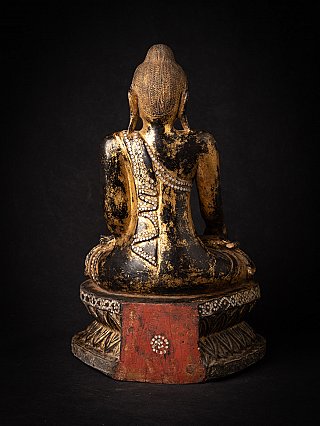 Burmese wooden Buddha statue, rear view with a red panel visible on the back of the base