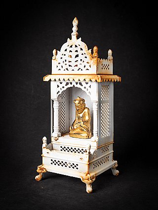 Buddha statue in Nepalese metal shrine, three-quarter left view