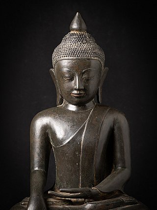 Frontal detail of face and upper torso of the Burmese bronze Buddha statue