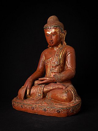 Wooden Burmese Buddha statue seated in bhumisparsha mudra, three-quarter view