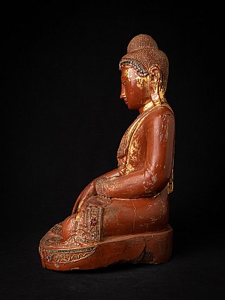 Burmese wooden Buddha statue seated in bhumisparsha mudra, left side profile