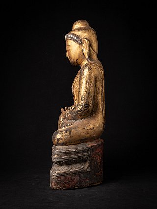 Burmese wooden Buddha statue, seated posture shown in left side profile