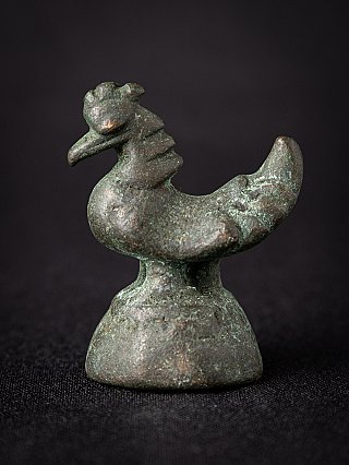 Antique Burmese bronze opium weight, bird-shaped form in side view on domed base