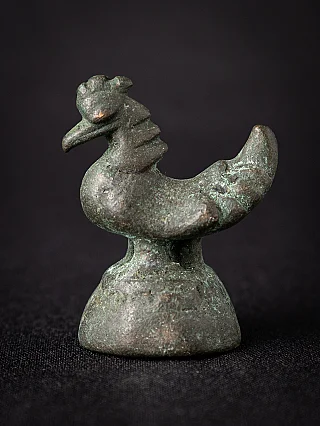 Antique Burmese bronze opium weight, bird-shaped form in side view on domed base