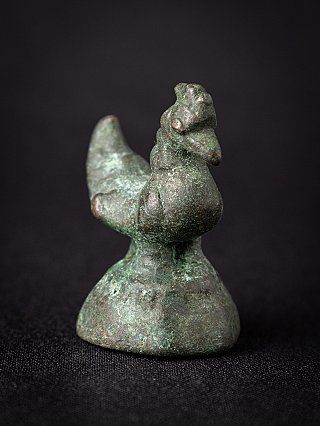 Antique Burmese bronze opium weight, three-quarter view highlighting the head and domed base