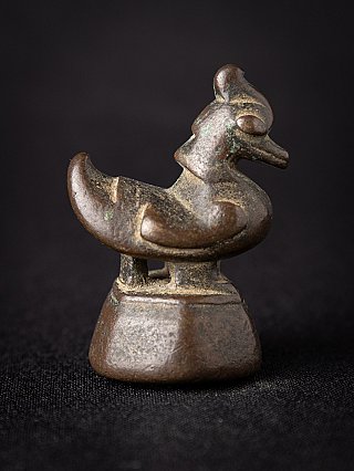 Antique bronze opium weight from Burma (Myanmar), side profile showing the curled tail