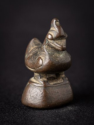 Bronze opium weight from Burma (Myanmar), three-quarter view showing head, chest and base