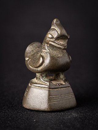 Burmese bronze opium weight showing bird figure in three-quarter view on base