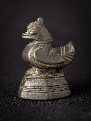 Antique Burmese bronze opium weight, side view showing bird-shaped form on stepped base