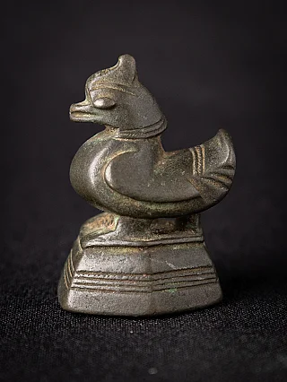Antique Burmese bronze opium weight, side view showing bird-shaped form on stepped base