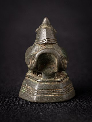 Antique Burmese bronze opium weight, rear view with tail opening and stepped base