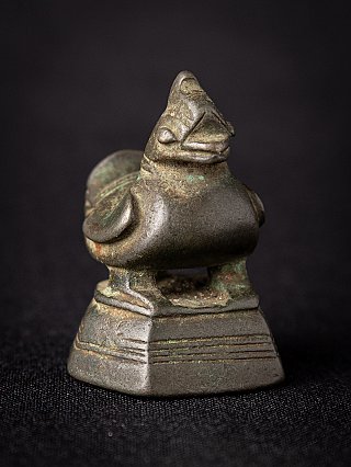 Antique Burmese bronze opium weight, three-quarter view highlighting the head and rounded body