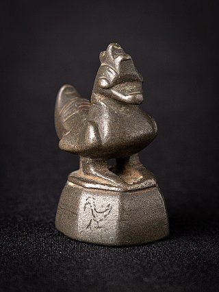 Bronze opium weight from Myanmar, 18th century, three-quarter view highlighting the head and base edge