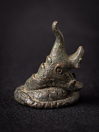 Bronze opium weight from Burma, three-quarter left view of animal head with patina