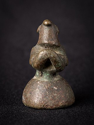 Bronze opium weight from Burma with bird head and domed base, front view