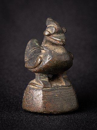 Antique bronze opium weight from Myanmar, three-quarter view highlighting head and rounded body