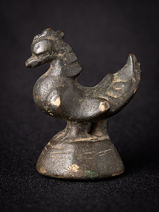 Bronze opium weight from Burma (Myanmar) in bird form on pedestal, three-quarter view