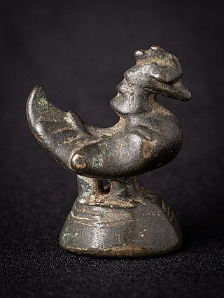 Bronze opium weight from Burma (Myanmar), side view with raised tail and aged patina