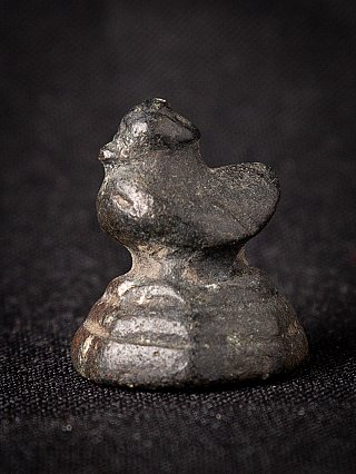 Bronze opium weight from Burma (Myanmar), 18th century, side view on dark cloth