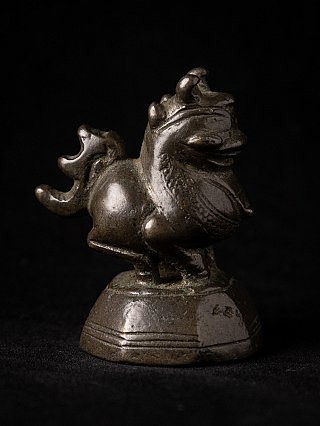 Bronze opium weight from Burma (Myanmar), animal figure with curled tail in three-quarter right view