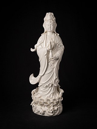Guanyin statue from China, full front view standing on a wave-and-lotus base in glossy white