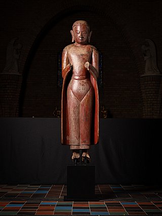 Large wooden Burmese monk statue, 17th century Ava period, standing with namaskara mudra, full front