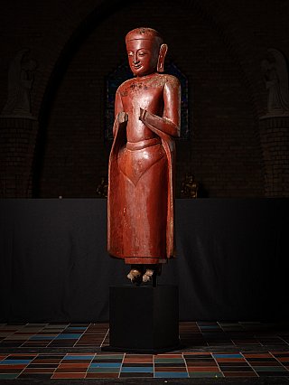 Burmese wooden monk statue, 17th century, standing in namaskara mudra, three-quarter left view