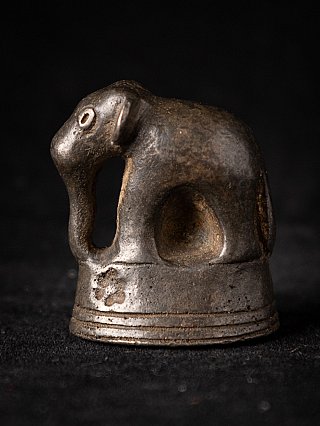 Burmese bronze opium weight showing an elephant in left side view with curved trunk
